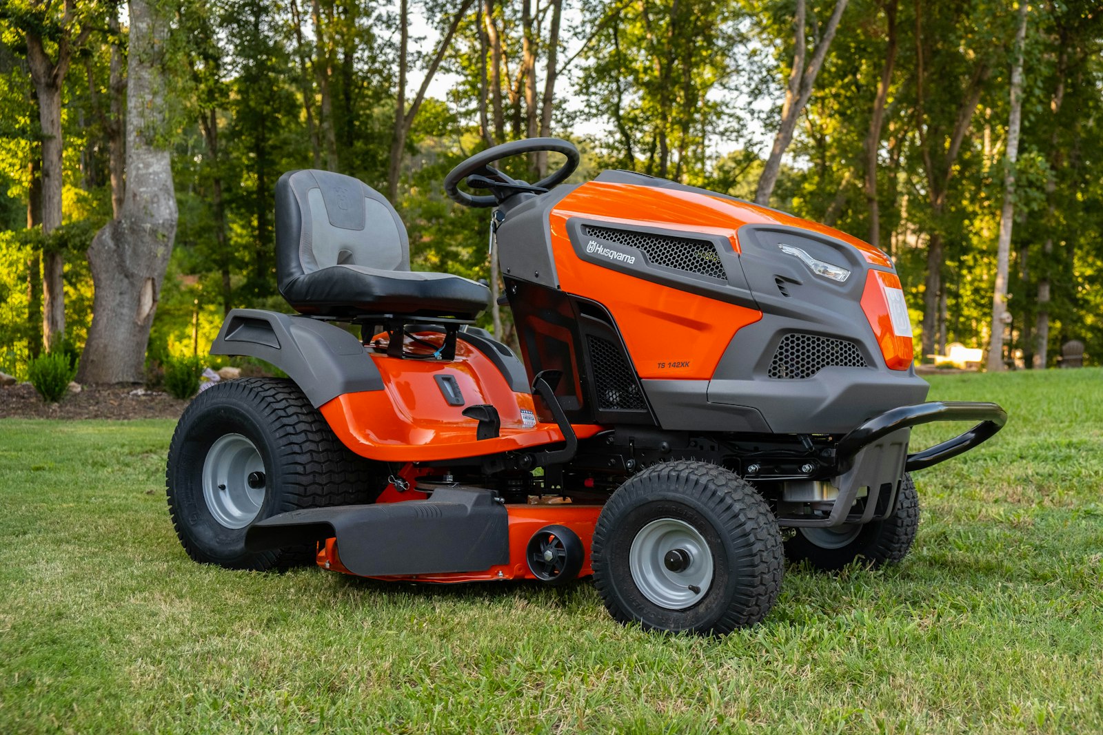 Walk-behind mower parked at the edge of a residential lawn between cuts.